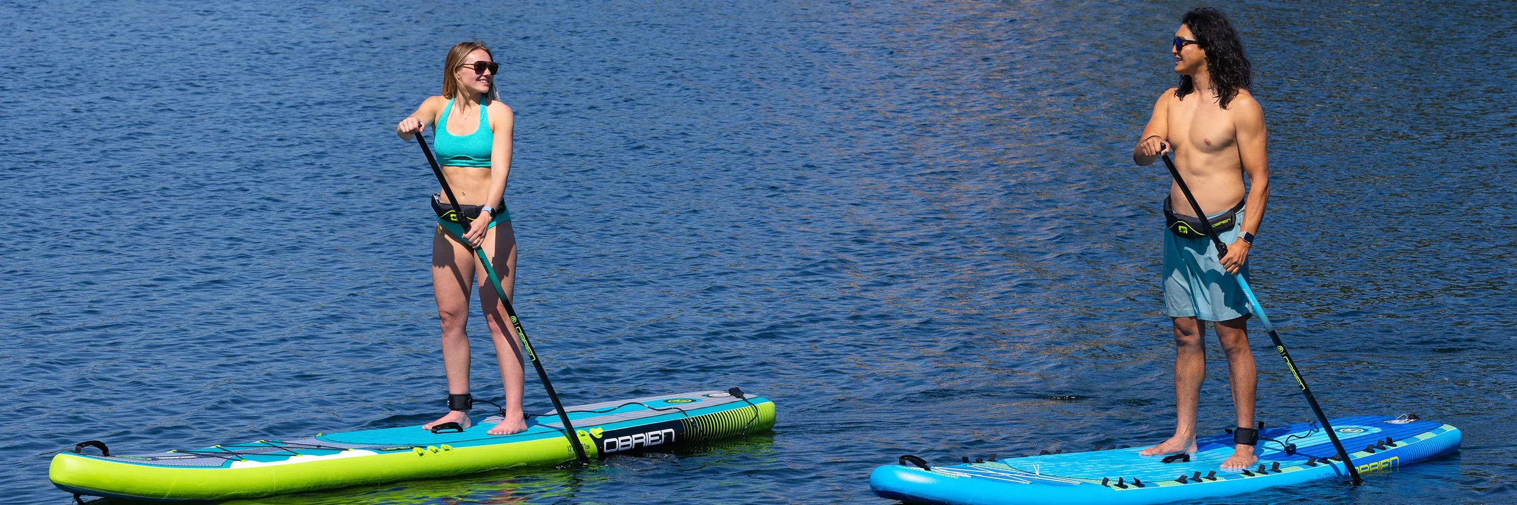 Paddleboard with paddle on beach